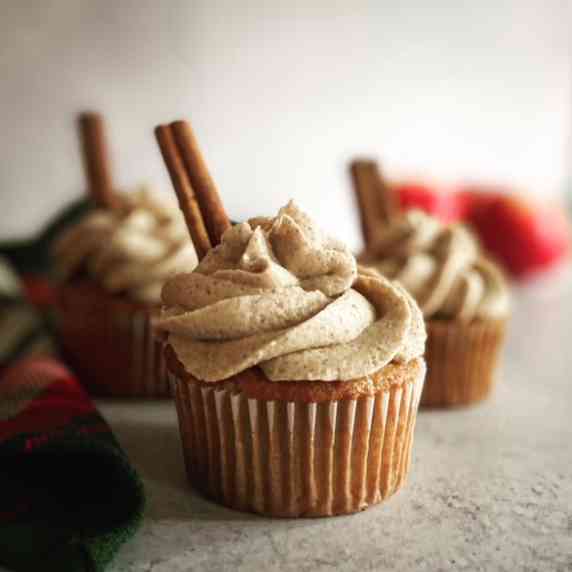 Three apple pie cupcakes with cinnamon cream cheese frosting