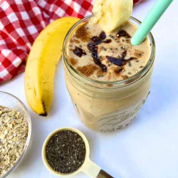 Banana chia smoothie with a drizzle of chocolate peanut butter and sprinkling of cinnamon
