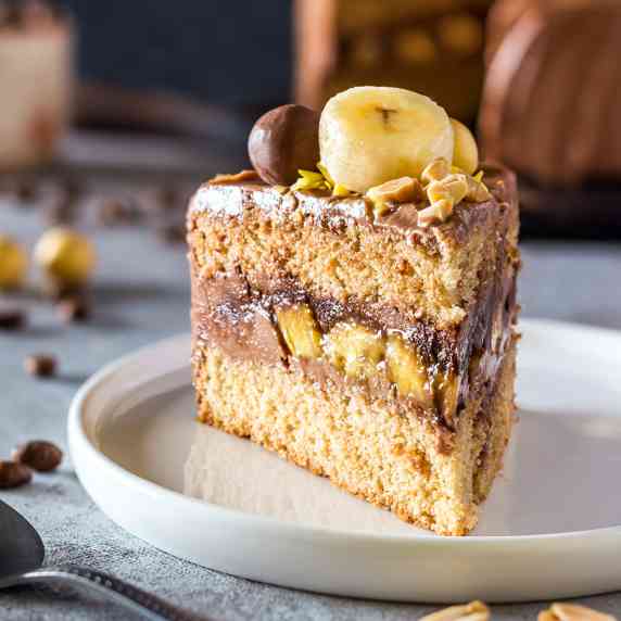 Slice of banana cake with coffee frosting and a layer of bananas inside