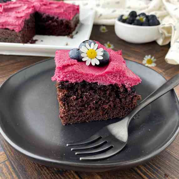 Slice of Blueberry Chocolate Cake on a black plate.