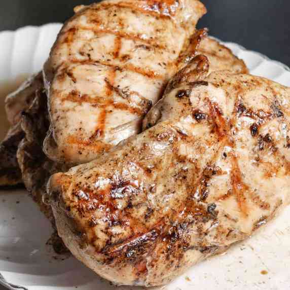 Grilled chicken breasts on a platter.