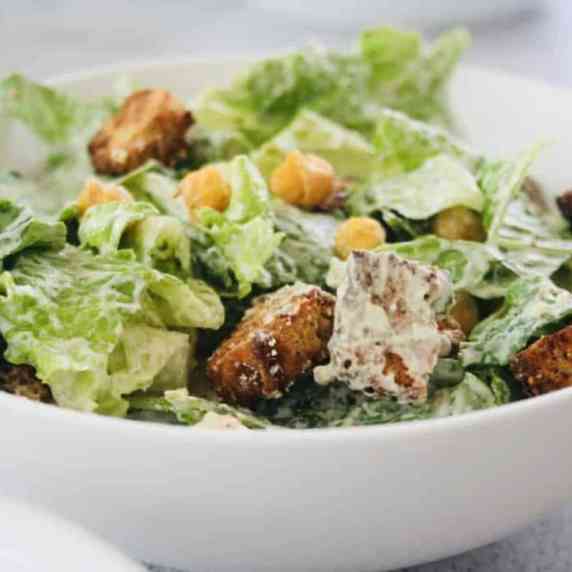 A tantalizing vegan Caesar salad with creamy cashew dressing, golden croutons, and chickpeas.