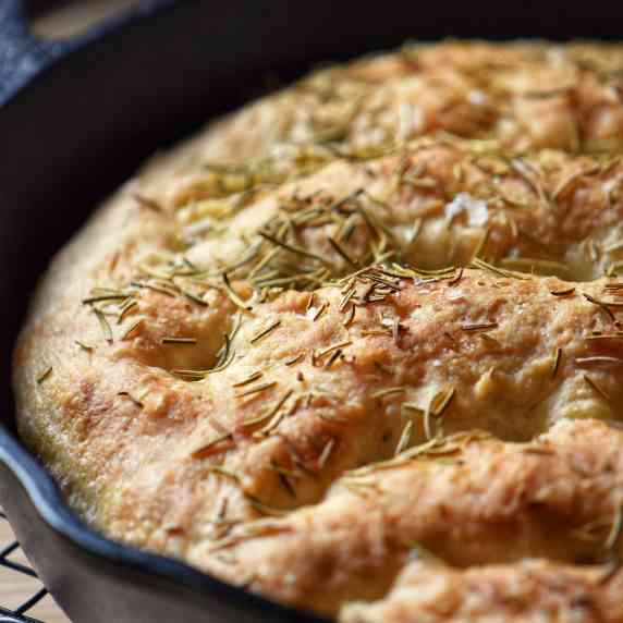 Rosemary focaccia in a cast iron skillet.