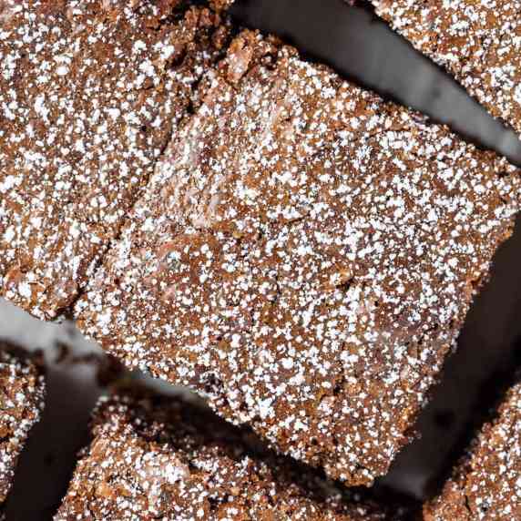 Coffee espresso brownies topped with a sprinkle of icing sugar.