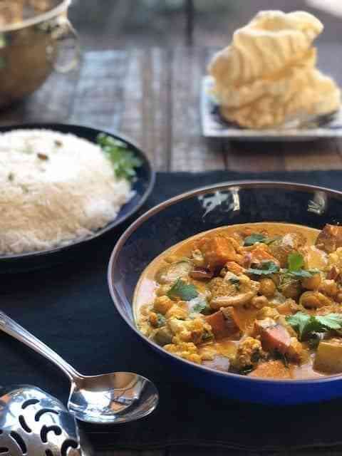 Indian curry in bowl with rice in bowl in background