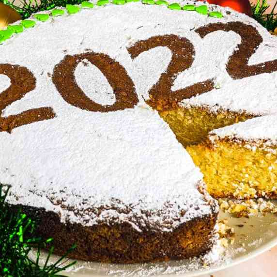 Greek new year cake decorated with powdered sugar and year date.