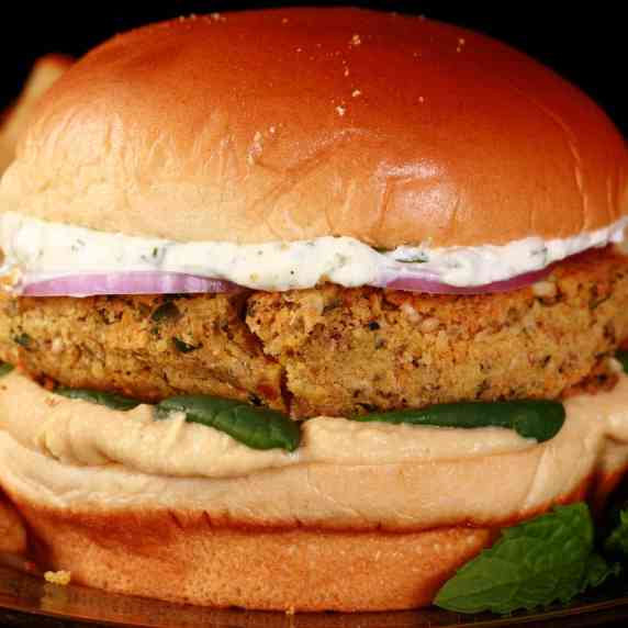 A dukkah spiced falafel burger with hummus and a labneh mint sauce.
