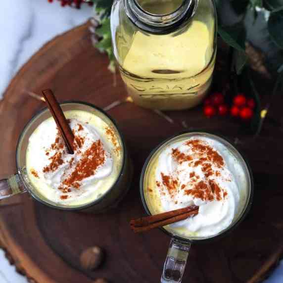 eggnog in glasses with whipped cream on top