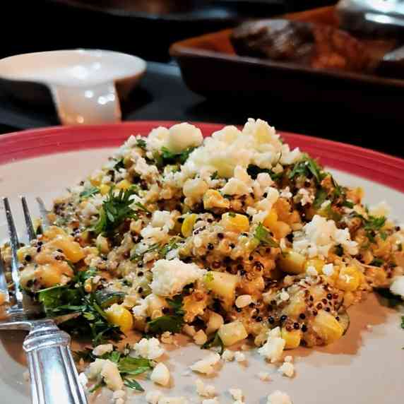 quinoa salad with roasted corn and cotija cheese on a plate