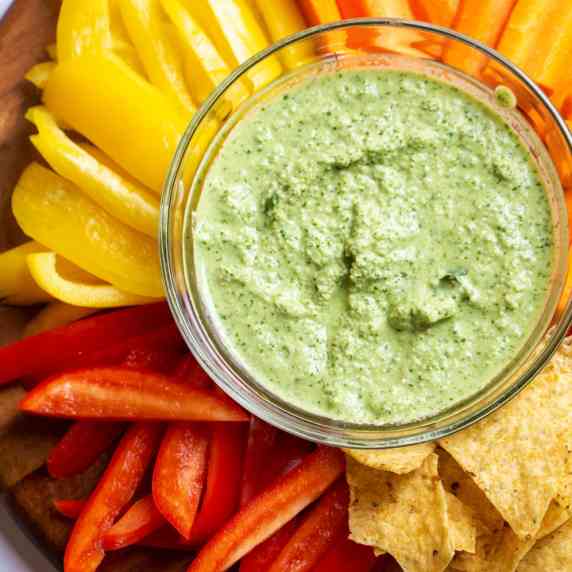 herb and garlic dip made out of cashews served with tortilla chips and bell peppers