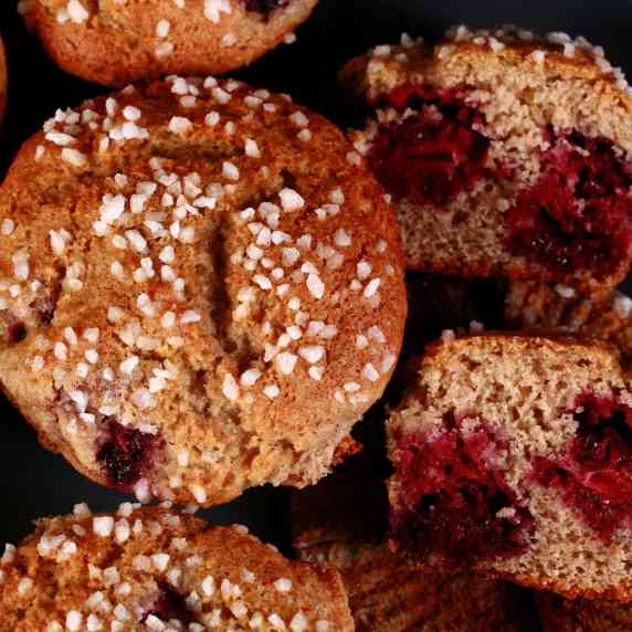 Several gluten free blackberry muffins on a plate.