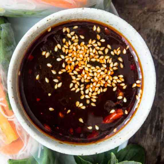 Closeup of hoisin dipping sauce served with fresh Vietnamese spring rolls