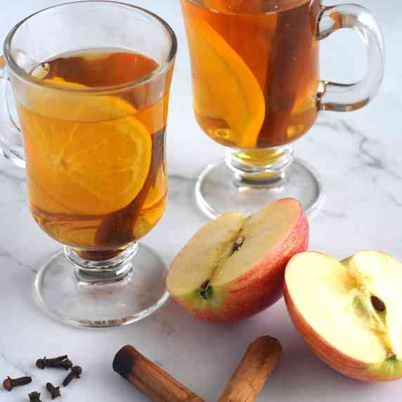 Two glasses of mulled apple cider.