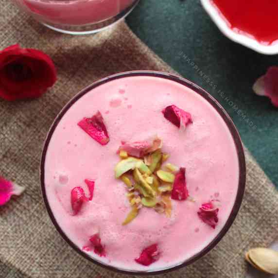 The velvety pink hue of rose lassi adds to its visual appeal.