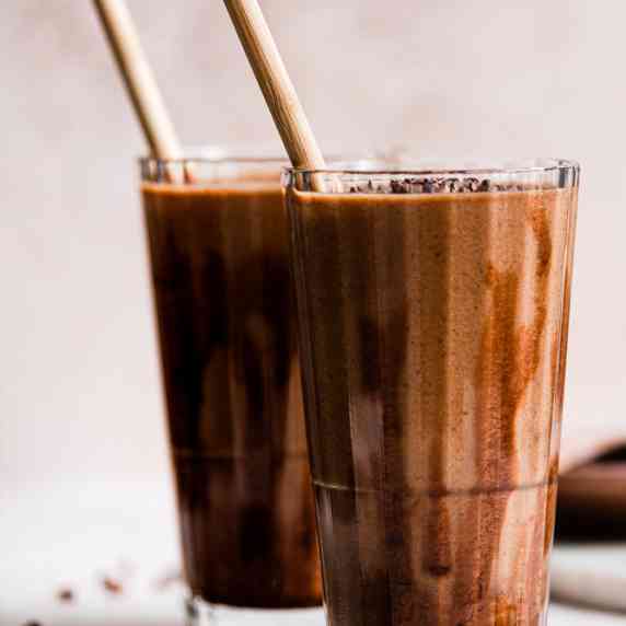Creamy chocolate smoothie in a glass for two