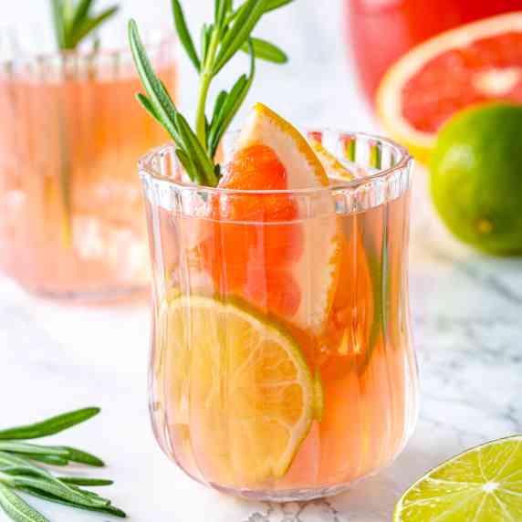 Virgin Paloma recipe in a glass decorated with rosemary sprig