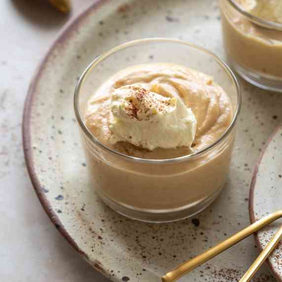 Two bowls of peanut butter mousse placed on a serving plate