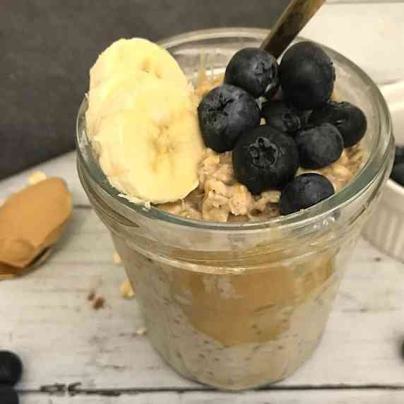 peanut butter overnight oats with blueberries and banana slices toppings