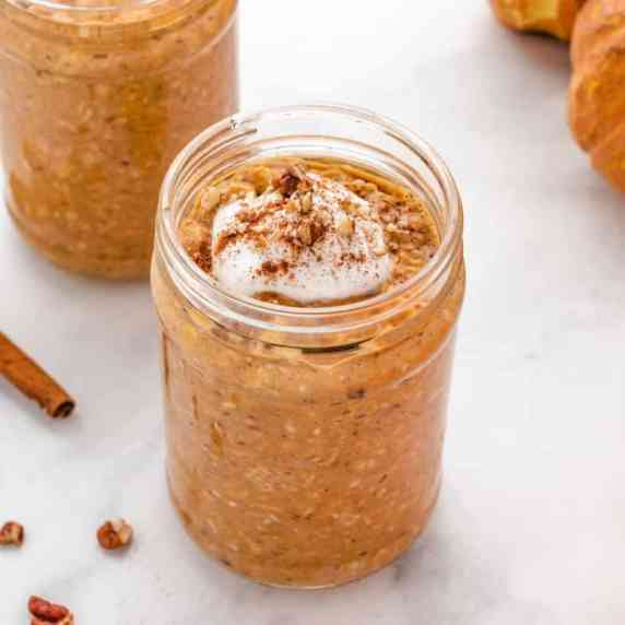 Pumpkin overnight oats in a jar with yogurt on top.