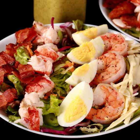 A bowl of seafood cobb salad.