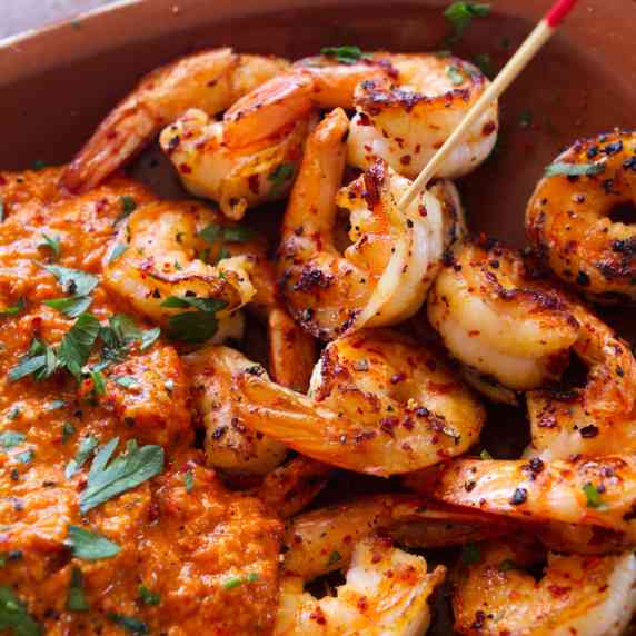 A tapas serving of grilled shrimp with a spicy romesco sauce. 