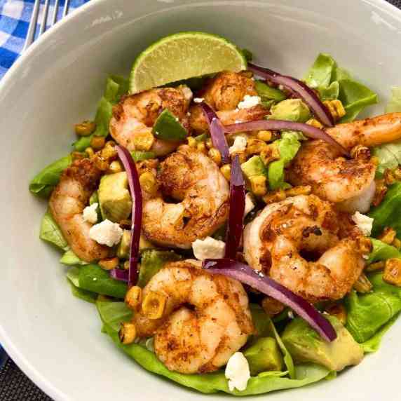Blackened shrimp salad with corn, feta cheese, avocado, and butter lettuce. 