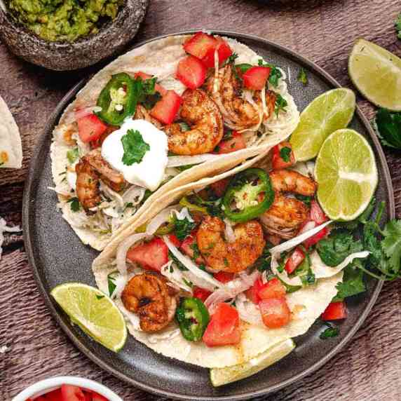 shrimp tacos with lime wedges