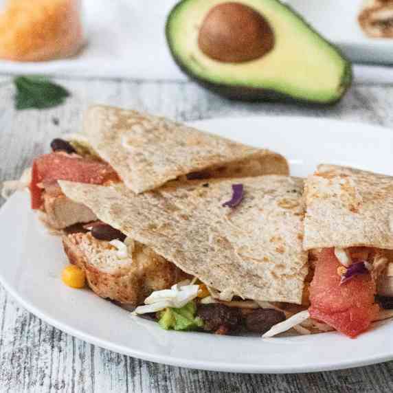 chicken quesadilla on plate with avocado