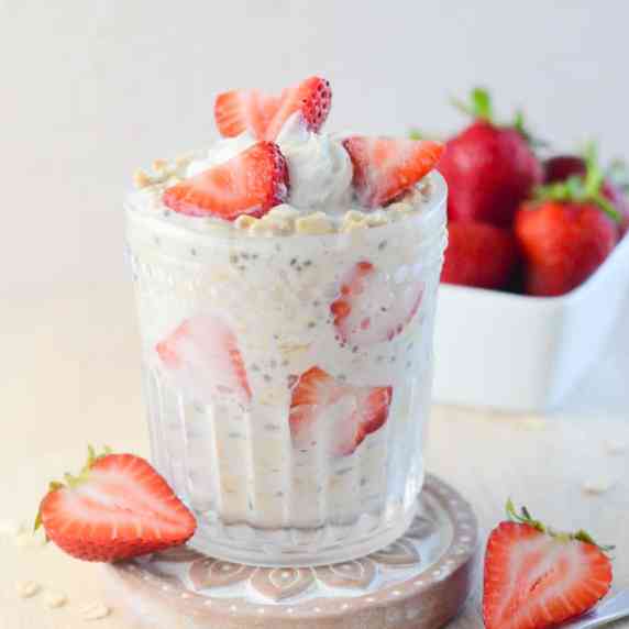 Close up of a cup of strawberries and cream overnight oats 
