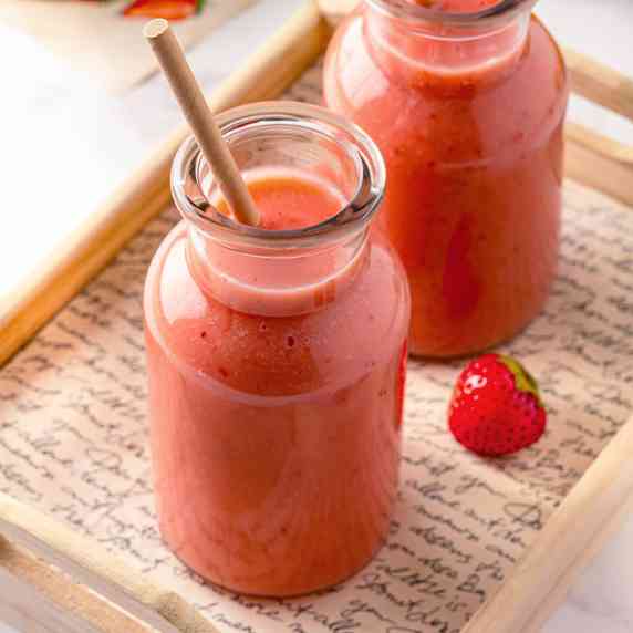 Two bottles with strawberry apple smoothie