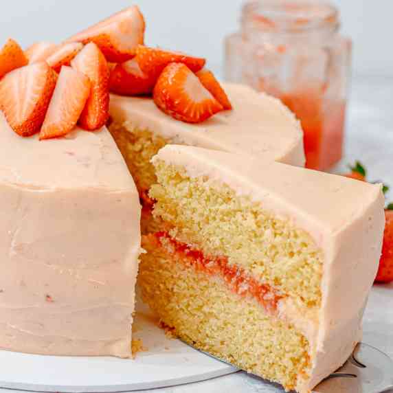 Vanilla cake with strawberry frosting, strawberry filling and fresh strawberries on top
