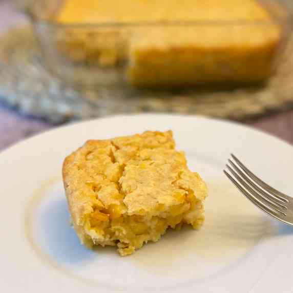 Plate with cornbread casserole and a fork.