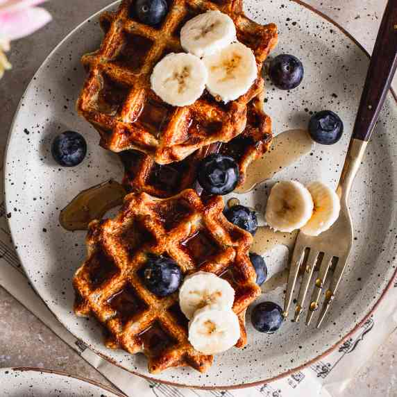 vegan waffles placed on a plate with fresh fruits