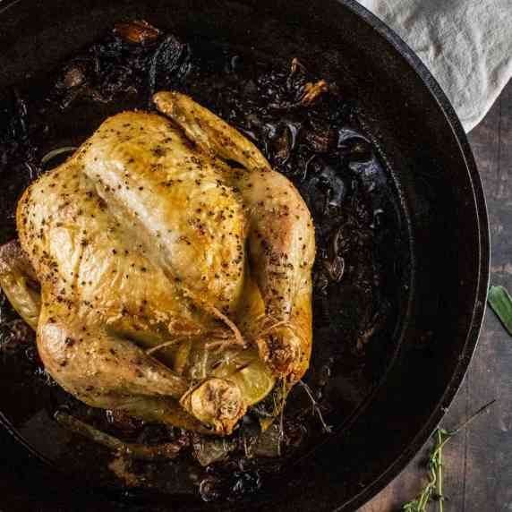 whole roasted chicken in a black cast iron pan