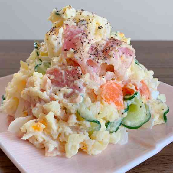 Potatoes, cucumbers, carrots, onions and, bacon mixed with mayonnaise.