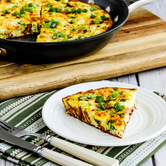 Bacon Frittata slice on serving plate with frittata in background