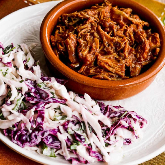 Low-Carb Slow Cooker Pulled Pork shown on plate with coleslaw.