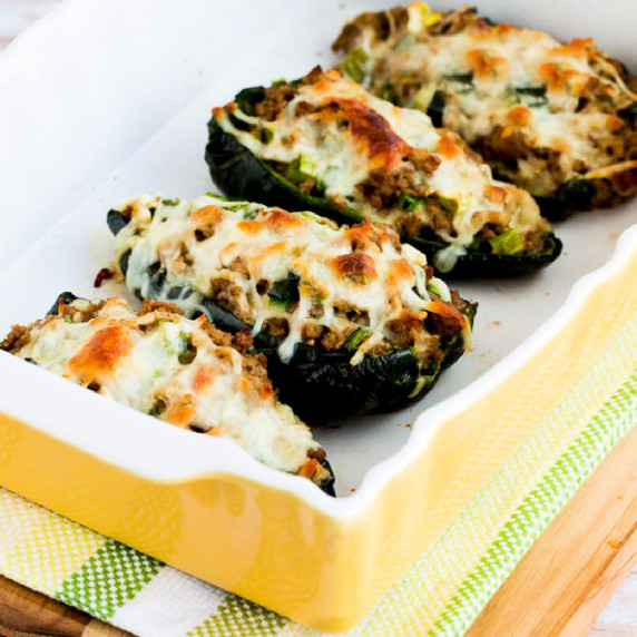 Four Stuffed Poblanos with Ground Turkey shown in baking dish.