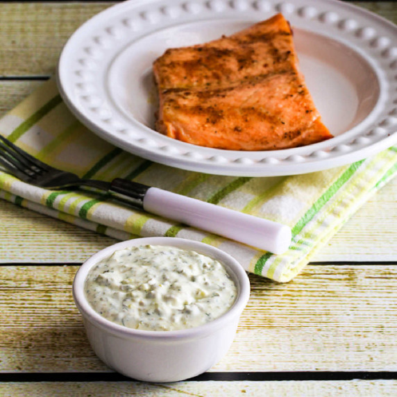 Double Dill Homemade Tartar Sauce shown in small dish with salmon in background.