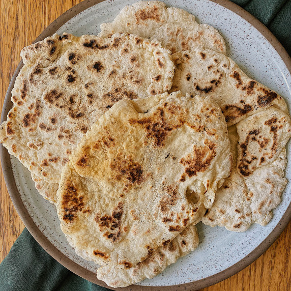 Plate of naan on a white and brown plate