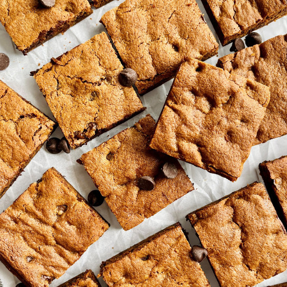 Chocolate chip cookie bars on parchment paper.