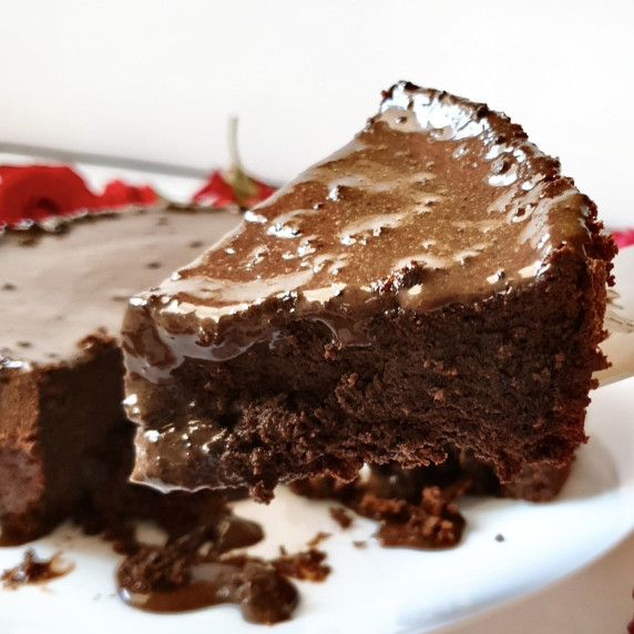 3 ingredient chocolate cake slice topped with chocolate ganache.