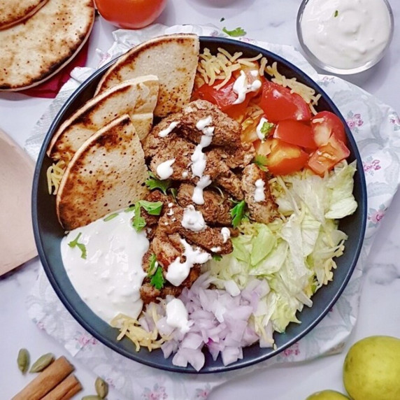 One Pot Chicken Shawarma Rice Recipe with Garlic Sauce in a black bowl.