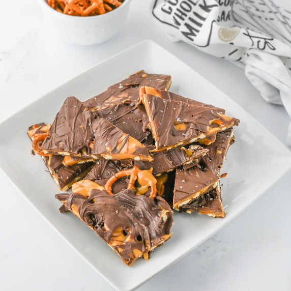 salted caramel pretzel bark on a white plate.