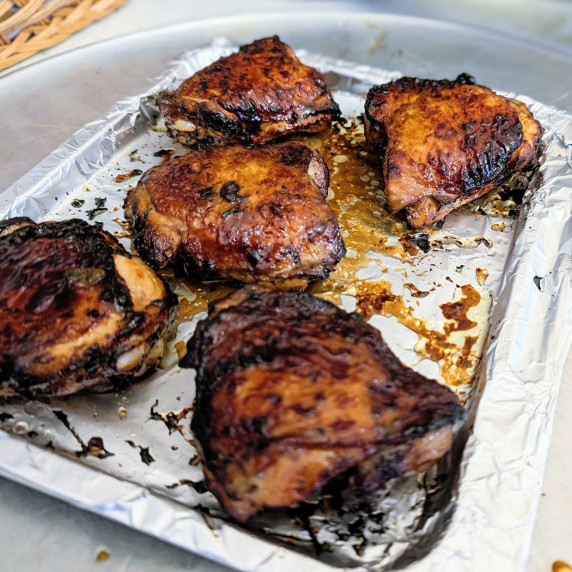 air fryer cooked soy-balsamic marinated chicken thighs on an air fryer tray