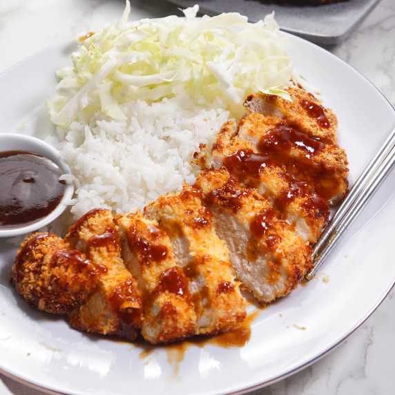 Air fryer chicken katsu served with rice and cabbage on a white plate