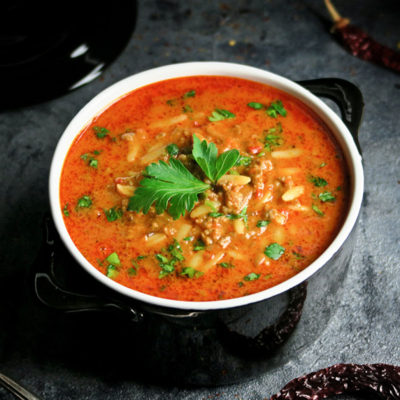 Creamy and spicy roasted red pepper and tomato soup with ajvar, beef and orzo
