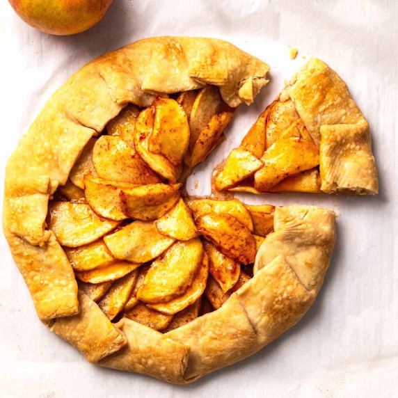 Overhead view of apple galette with a slice cut out.