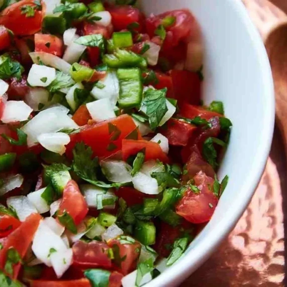 Authentic pico de gallo, fresh salsa on whte bowl