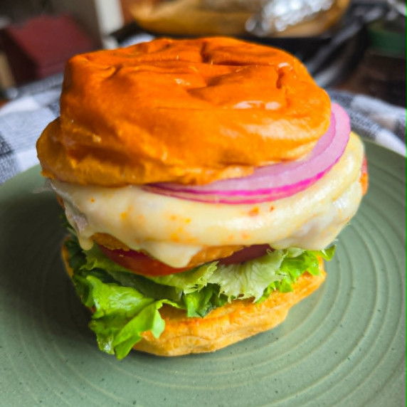 Golden buns, melty white cheese, red onions and pops of green lettuce.